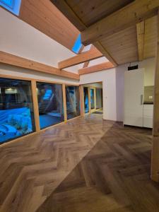 an empty living room with wooden floors and wooden ceilings at Kleine Heubühne im Emmental mit 2 Schlafzimmer und 2 Schlafsofas in Rüegsbach