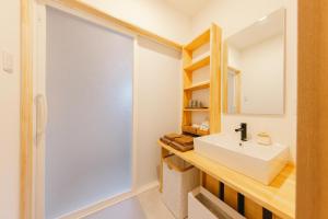 a bathroom with a sink and a mirror at Stay Okumatsusaka in Matsuzaka