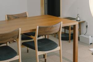 a wooden table with two chairs and a wooden table at Stay Okumatsusaka in Matsuzaka +9 photos