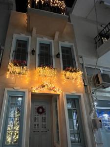 a house with christmas lights on the front of it at Philomena Suite in Chrysoupolis