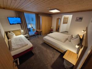 a hotel room with two beds and a television at Apart Lenz in Ischgl