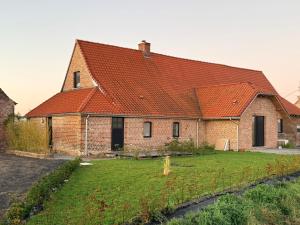 a large brick house with an orange roof at Duplex neuf et cosy vue Mont des Cats in Météren