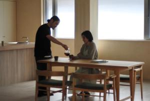 a man and a woman sitting at a table at 雲居月-kumoizuki- in Ginowan