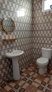 a bathroom with a white toilet and a sink at See Sea Hostel & Resto in Jepara