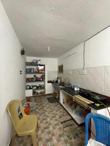 a kitchen with a counter and a table and chairs at Radiant Hill Homestay in Kodaikānāl