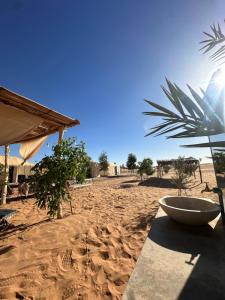 a bowl on a table on a sandy beach at Le xury camp in Hassilabied
