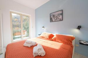 a bedroom with a bed with towels on it at Palia's Hotel in Laino Borgo +148 photos