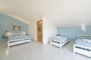 two beds in a room with blue walls at Palia's Hotel in Laino Borgo +105 photos