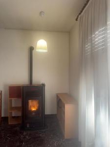 a living room with a wood stove in a room at Tamika's House in Udine