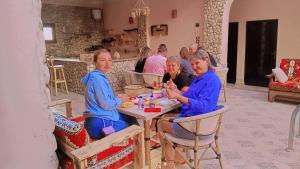 a group of people sitting at a table at amzran hotel siwa امزران سيوة in Siwa