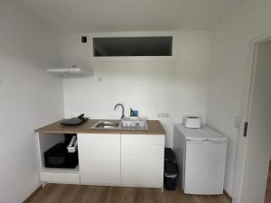 cocina con fregadero, lavadora y secadora en Modernes 2-Zimmer Apartment in Aschaffenburg, en Aschaffenburg