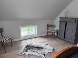 a living room with a wooden floor and a window at Huisje weltevreden in Ekshärad