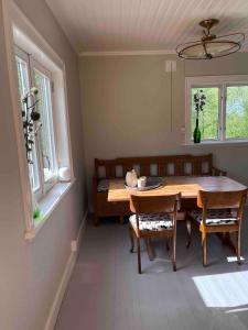 a dining room with a wooden table and chairs at Huisje weltevreden in Ekshärad +11 photos