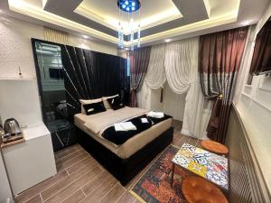 a bedroom with a king sized bed and a table at TH Old City Hotel in Istanbul