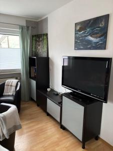 a living room with a large flat screen tv at Ferienwohnung Aurach in Aurach