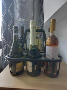 three bottles of wine sitting on a shelf at Ferienwohnung Castelnau in Trier
