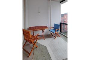 a table and two chairs sitting on a balcony at Kotimaailma Woody 3 in Lahti