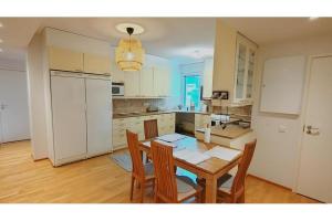 a kitchen with a table and chairs in a kitchen at Kotimaailma Woody 3 in Lahti