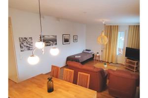 a living room with a couch and a table at Kotimaailma Woody 3 in Lahti