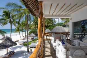 a resort with chairs and umbrellas on the beach at Waterlovers Beach Resort in Diani Beach