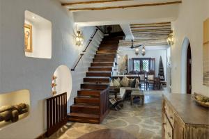 a staircase in a home with a living room and dining room at Waterlovers Beach Resort in Diani Beach +57 photos