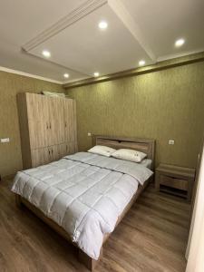 a bedroom with a large bed in a room at Horizont-apartment11 in Bakuriani
