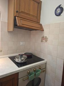a kitchen with a stove with pots and pans on it at Belvedere 160 in Feltre +13 photos