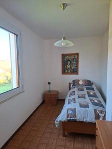 a bedroom with a bed and a window at Belvedere 160 in Feltre