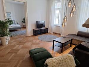 a living room with a couch and a table at Innsbruck Residence in Innsbruck