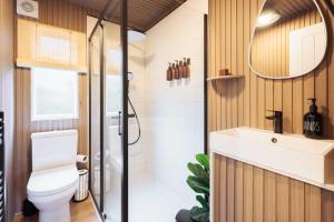 a bathroom with a toilet and a sink at Secluded Sanctuary On The River in Christchurch +30 photos