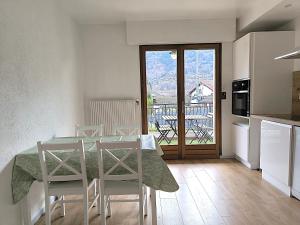 a kitchen and dining room with a table and chairs at Appartement Le Bargy in Scionzier