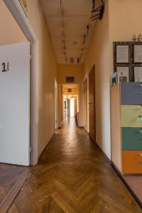 an empty hallway in an office building with wooden floors at Kaunas Center Hostel - Self-Check In in Kaunas