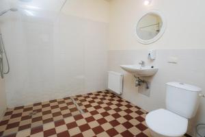 a bathroom with a toilet and a sink at Pilsbrūzis in Odziena