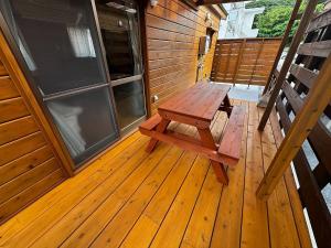 a wooden bench sitting on the porch of a house at La prima stella - Vacation STAY 54161v in Nakasone +1 photo