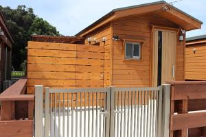 a wooden cabin with a fence and a gate at La prima stella - Vacation STAY 54161v in Nakasone