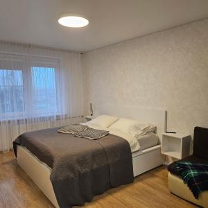 Postel nebo postele na pokoji v ubytování Buto nuoma Žemaitės gatvėje