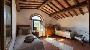 Postel nebo postele na pokoji v ubytování Agriturismo Podere Cortilla + 50 fotografií