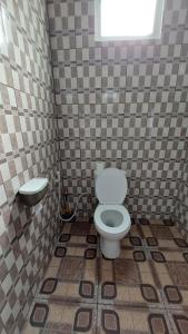 a bathroom with a toilet and a sink at See Sea Hostel & Resto in Jepara