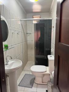 a bathroom with a toilet and a sink and a shower at Centro Brasil Apartamento in Santarém