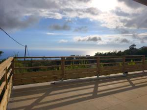 a wooden fence on a bridge with a view of the ocean at Kaz Lorizon in Petite Île