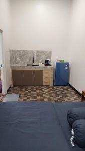 a kitchen with a sink and a counter at See Sea Hostel & Resto in Jepara