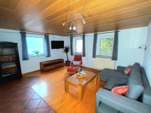 a living room with a couch and a table at Gästehaus am Hofberg in Thalmässing