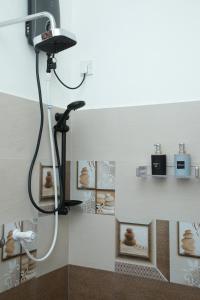 a shower in a bathroom with a black shower head at Moon&Back Homestay in Galle +32 photos