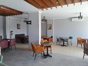 a room with chairs and tables and a piano at Juliana Beach Hurghada in Hurghada