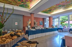 a bakery with a table with baskets of bread at Hotel du Lac in Talloires