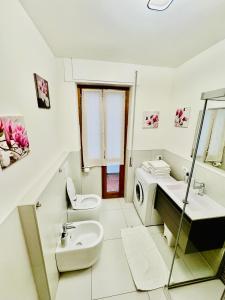a white bathroom with a sink and a toilet at Nido tra monti in Sondrio +49 photos