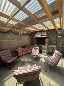 a living room with purple chairs and a table at Sofia II in Valdivia