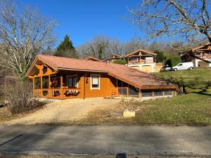 a small house with a roof on a hill at Chalets du Soleil in Mauroux