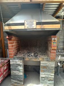 an outdoor grill with a sign on top of it at Sofia II in Valdivia