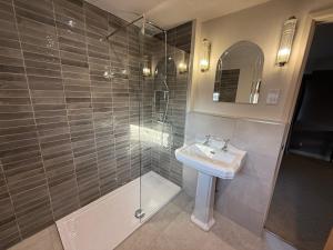 a bathroom with a shower and a sink at The Lord Raglan in Staplehurst